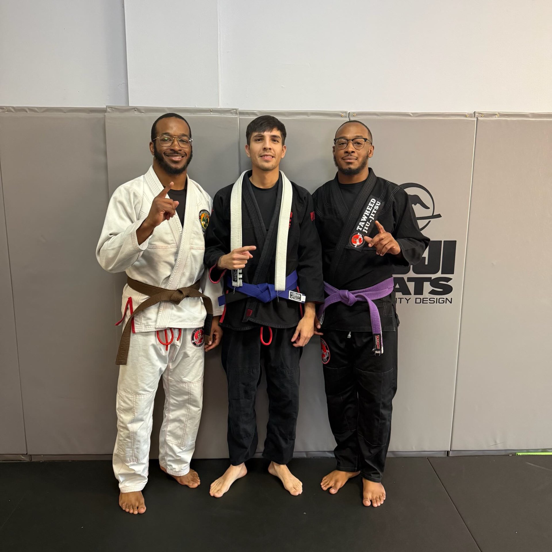 Three teammates on the mats