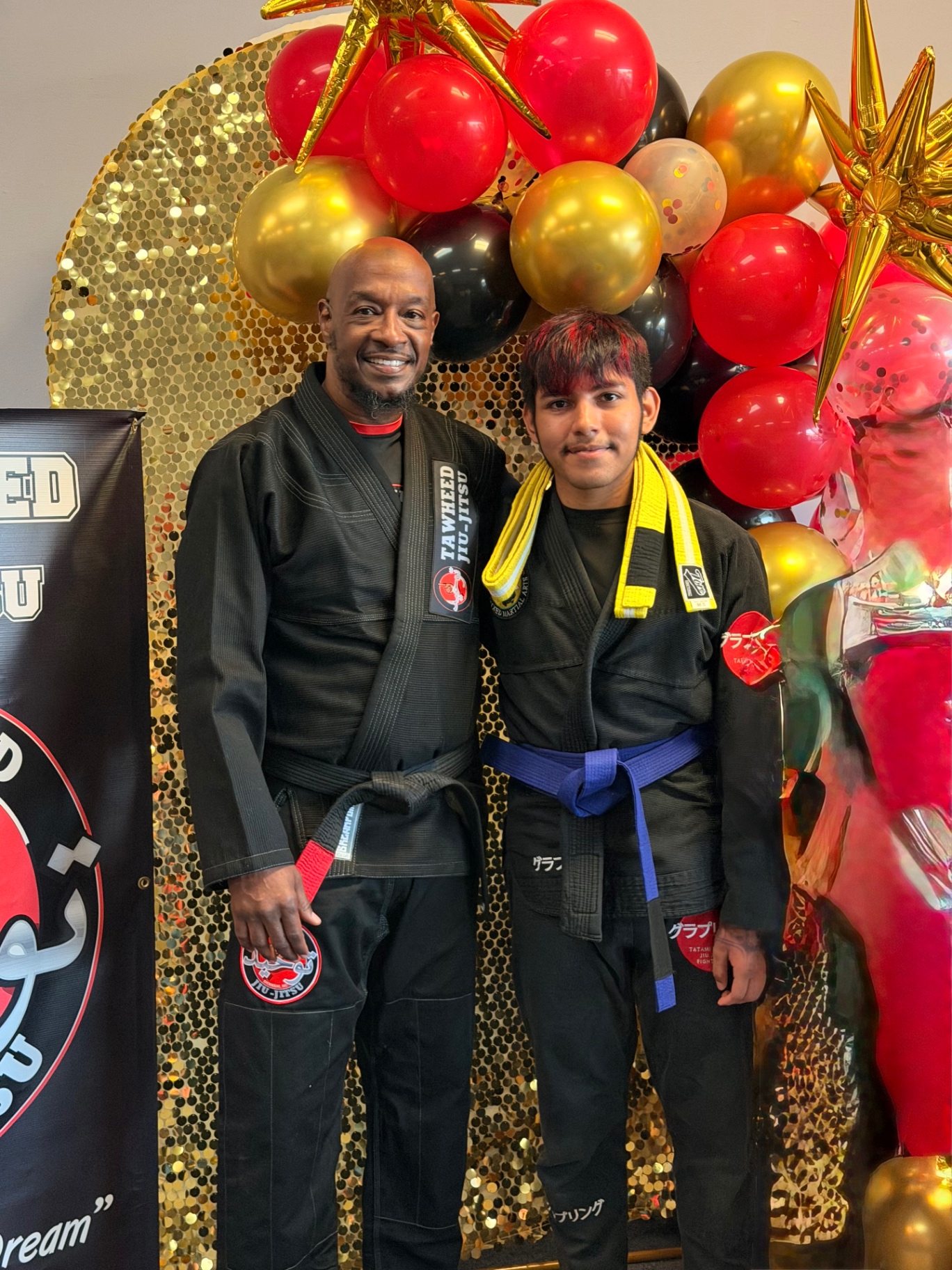 Student promoted to blue belt with yellow stripe